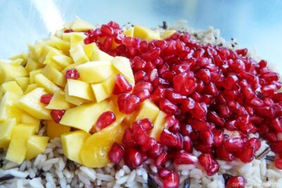 Mango and Pomegranate seeds in bowl of rice