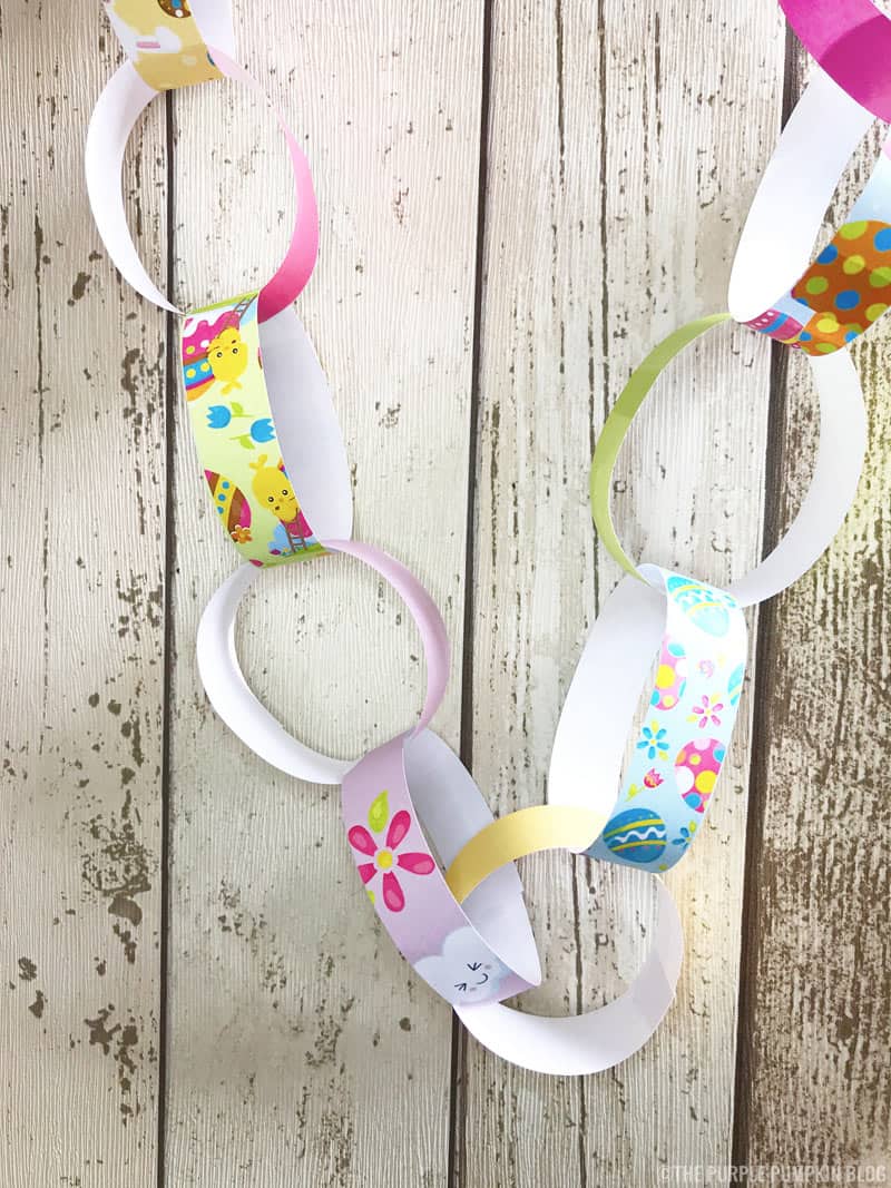 These free printable Easter decorations - paper chains - are super cute, and so simple to make! Just print, cut, loop, link and stick to form long chains to decorate with at Easter. A great Easter activity for kids and the whole family! #PrintableEasterDecorations #EasterPaperChains #PaperChains #ThePurplePumpkinBlog #FreePrintables