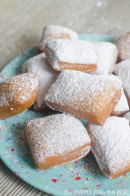 A plate stacked with beignets