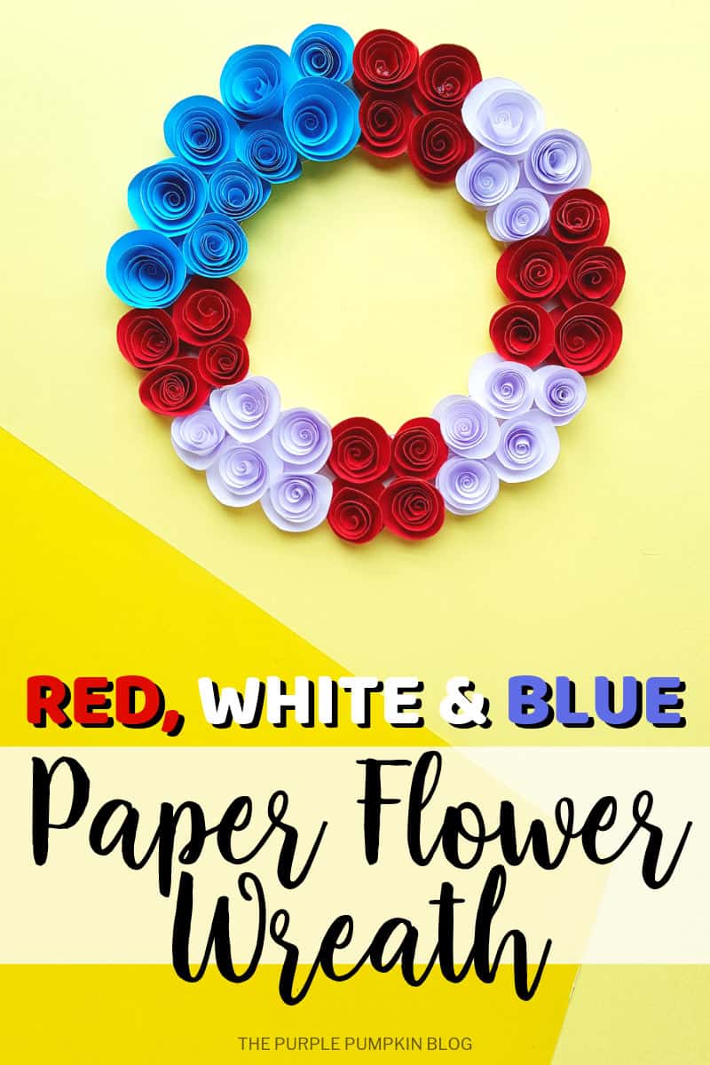 A paper flower wreath, with red, white and blue paper roses on a yellow background