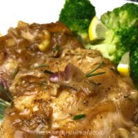 a plate of lemon rosemary chicken with broccoli florets
