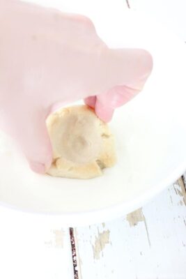 Dipping cookies into melted white chocolate