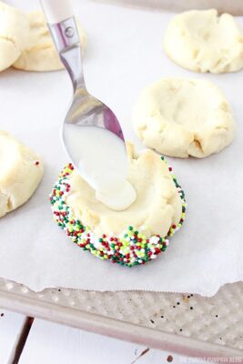 Spooning melted chocolate into cookies