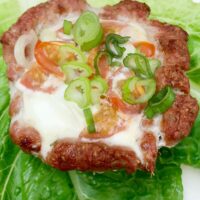 An Egg & Pork Cup sitting on lettuce leaves