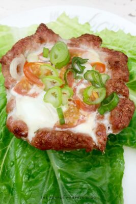 An Egg & Pork Cup sitting on lettuce leaves