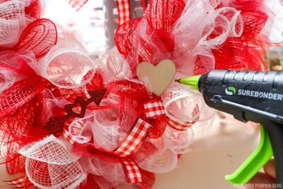 Using Hot Glue Gun To Attach Wooden Hearts