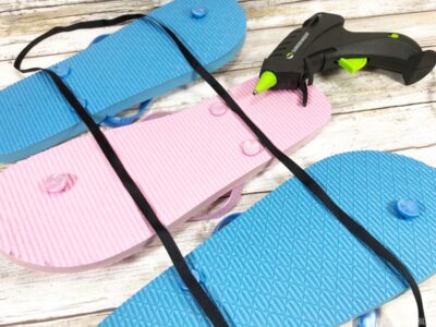 Attaching ribbon to flip flops sign