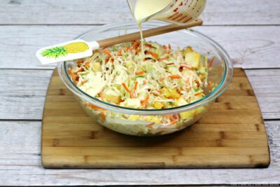 Pouring dressing on coleslaw