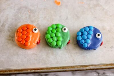 Candy eyeballs and lips added to cookie fish