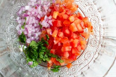 chopped tomato, red onion, and cilantro in bowl