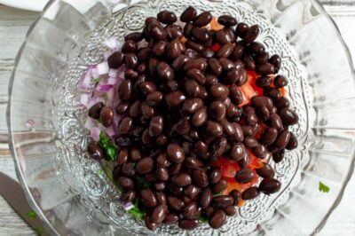 Black beans added to bowl