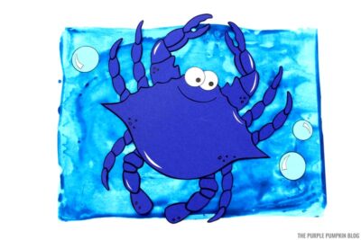 paper crab on painted ocean background