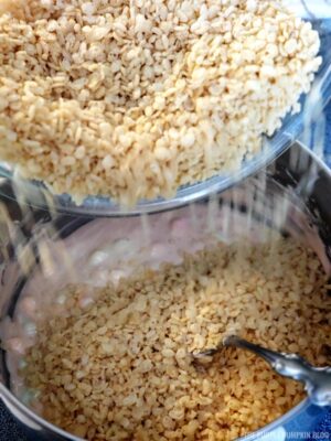 Pouring rice cereal into pan