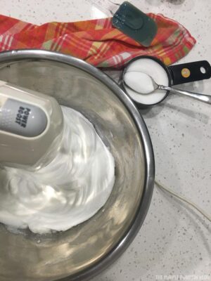 Adding sugar to whisked egg whites