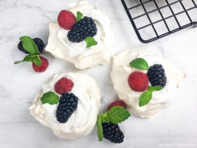 mini pavlovas topped with fresh berries