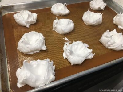 Prepared mini pavlovas on baking tray