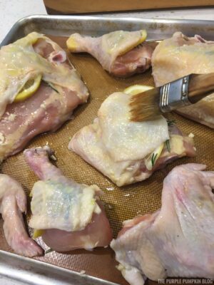 Brushing olive oil onto chicken
