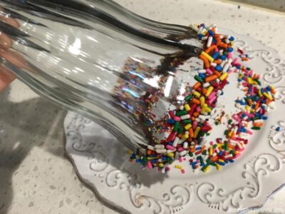 Dipping glass in sprinkles