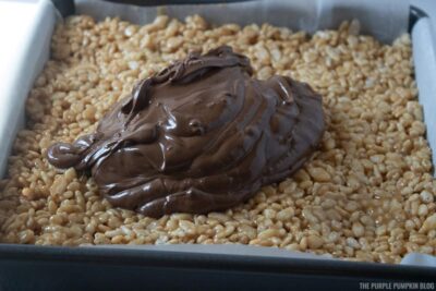 Adding melted chocolate and butterscotch to Rice Krispies pan