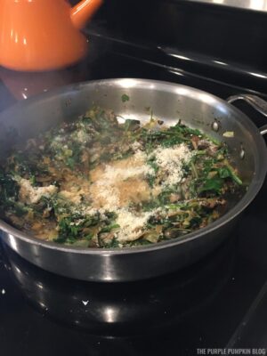 Adding Parmesan to sauteed mushrooms and spinach