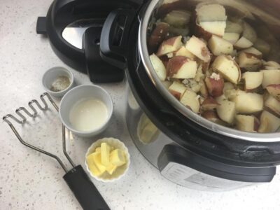Adding cream and butter to potatoes