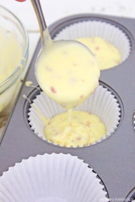 Adding cupcake batter to liner
