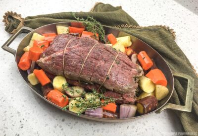Vegetables placed around beef tenderloin