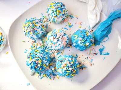 Adding Shark Sprinkles to Decorate Cocoa Bombs