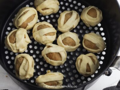 Prepared Mummy Meatballs in Air Fryer Basket