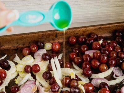 Adding Oil to the fennel and grapes