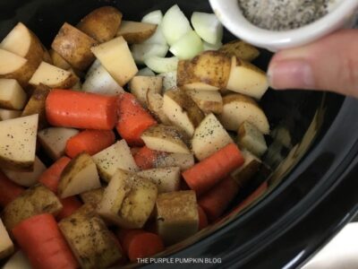 Adding Veggies to Slow Cooker Pot