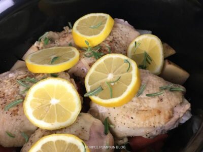Placing Chicken on top of Veggies with Lemon Slices