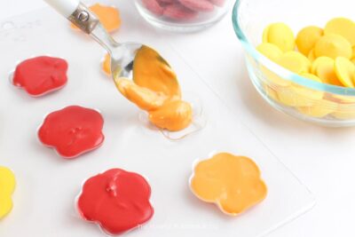 Adding Orange Melted Candy to Paw Print Mold