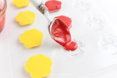 Adding Red Melted Candy to Paw Print Mold