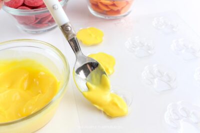 Adding Yellow Melted Candy to Paw Print Mold