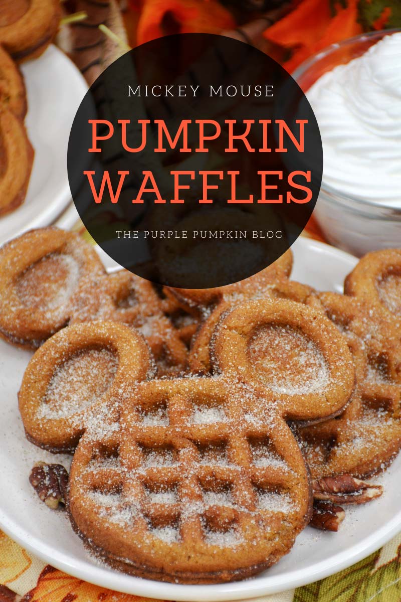 A pile of Mickey Mouse-shaped waffles dusted with sugar on a plate, with more waffles and a bowl of whipped cream in the background. Text overlay says "Mickey Mouse Pumpkin Waffles". Similar photos of the recipe from various angles are used throughout with different text overlays unless otherwise described.