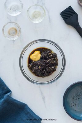Mixing Balsamic and Olive Tapenade Dressing Together in Bowl