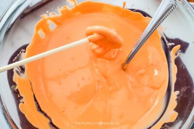 Dipping Pretzels into Melted Candy
