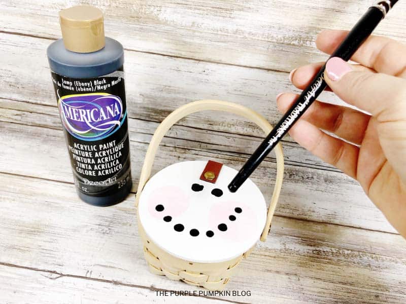 Painting Eyes and Mouth on Snowman's Face