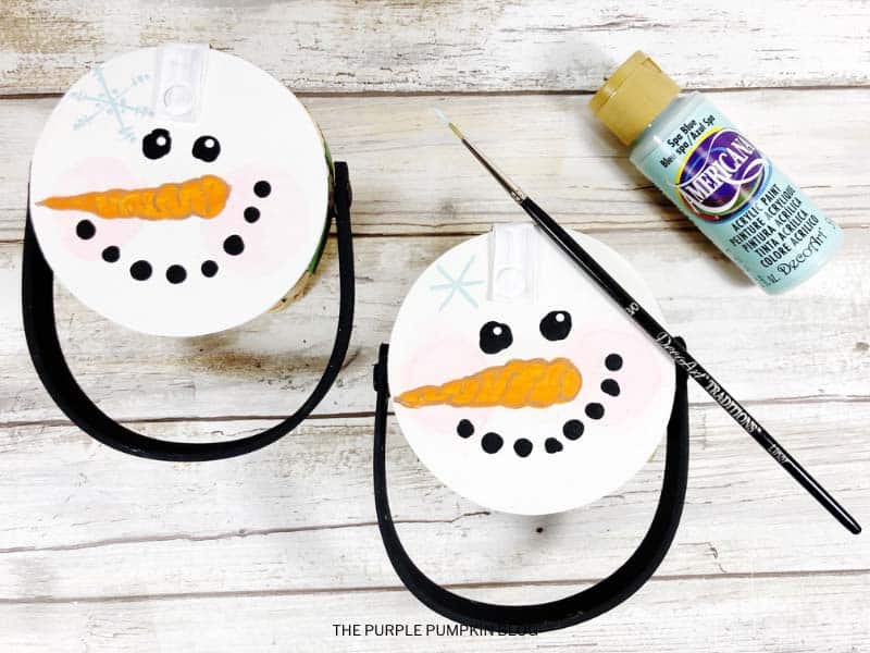 Painting Snowflake on Snowman's Face