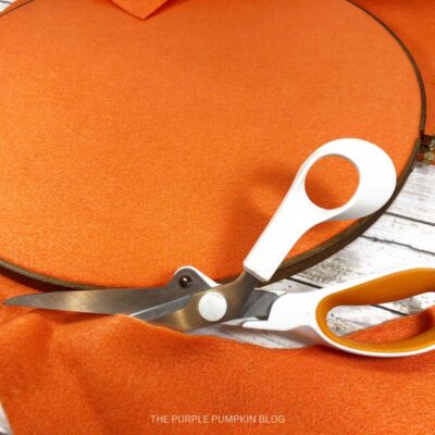 Cutting Excess Orange Felt Away From Hoop