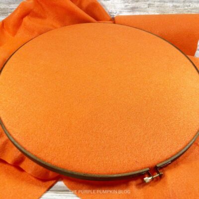 Placing Orange Felt into Hoop