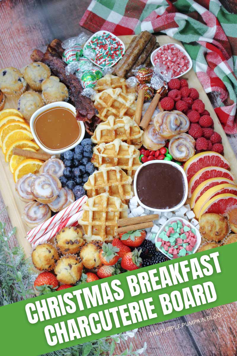 A wooden board filled with waffles, mini muffins, mini cinnamon rolls, fresh berries, bacon, sausages, sliced citrus fruit, bowls of sauce, and Christmas treats. The text overlay says "Christmas Breakfast Charcuterie Board". Similar photos of the recipe from various angles are used throughout with different text overlays unless otherwise described.