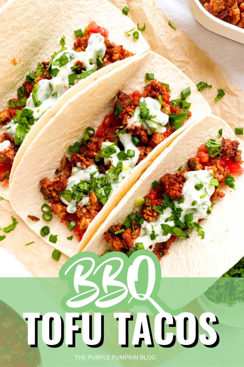 Three soft tacos filled with BBQ tofu mixture and garnished with sour cream topping and chopped green onions. The text overlay says"BBQ Tofu Tacos" Similar photos of the recipe from various angles are used throughout with different text overlays unless otherwise described.