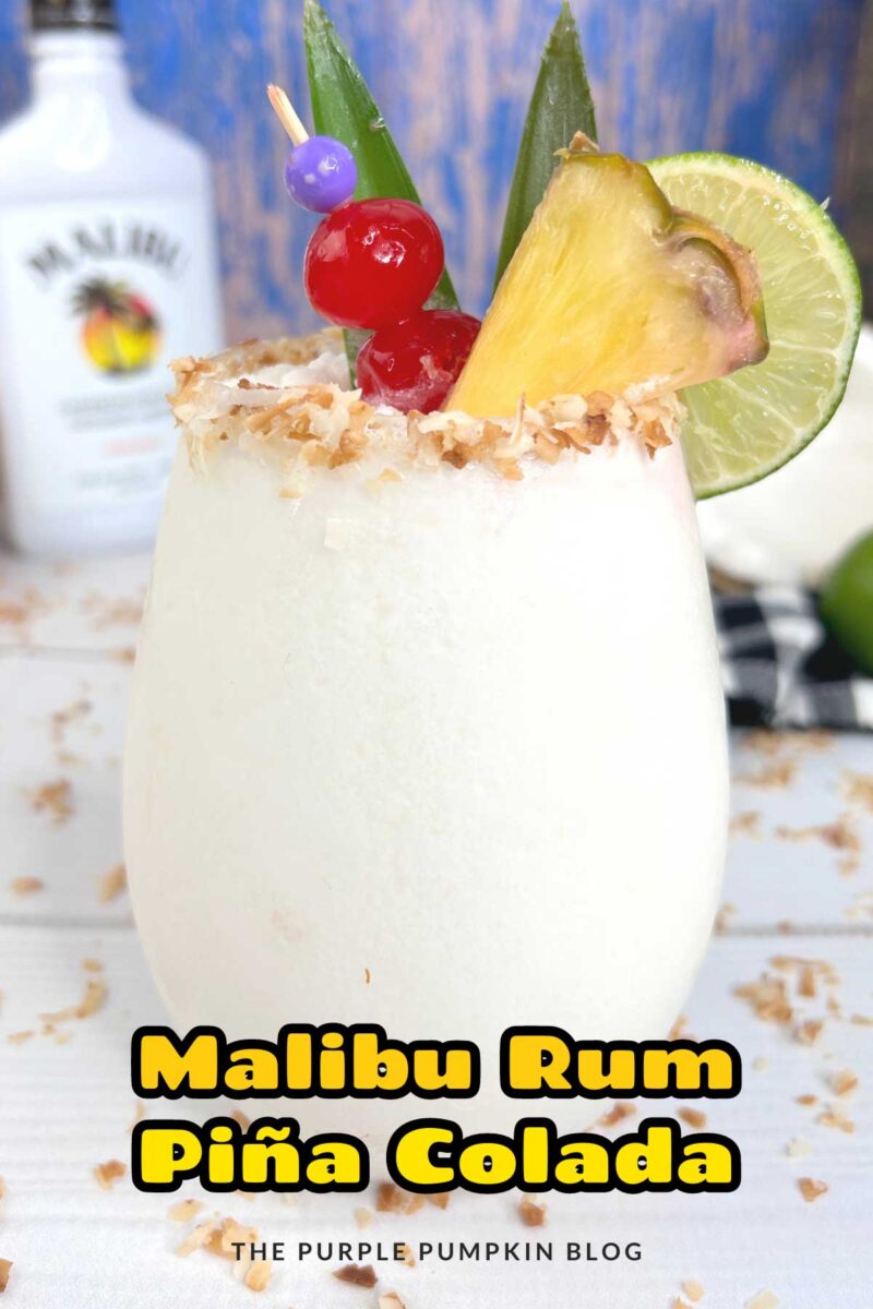 A glass filled with white frozen drink. The glass is rimmed with coconut flakes, and garnished with cherries, a lime slice, a pineapple wedge and leaves. A Malibu bottle, coconut and limes are in the background. The text overlay says"Malibu Rum Piña Colada" Unless otherwise described, images of the same cocktail feature throughout with different text overlays.