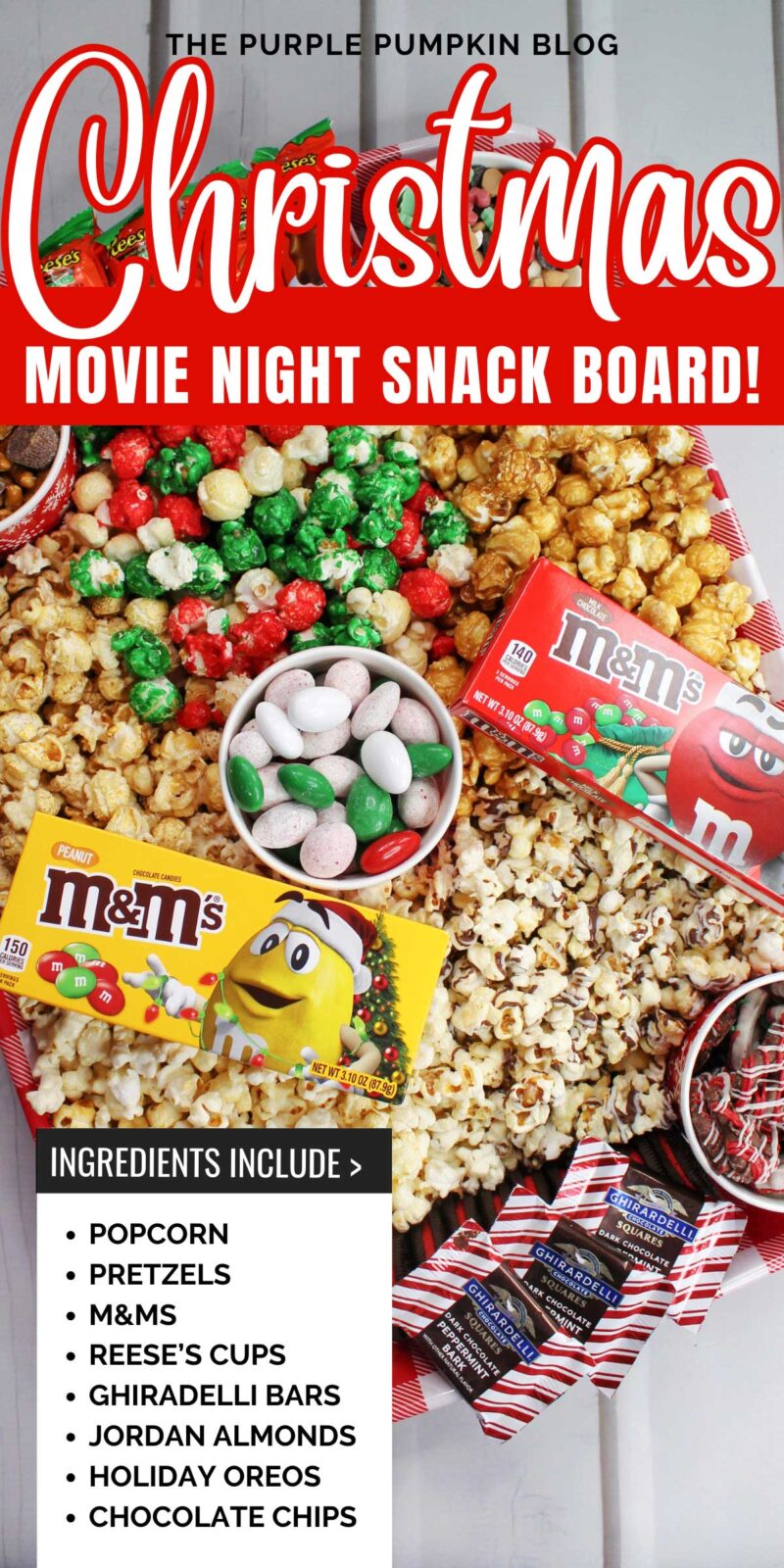 A red gingham tray, filled with pots of candy, pretzels, and chocolate chips, surrounded by various popcorn flavors, and topped with boxes of M&Ms and packets of Reese's Christmas Trees.