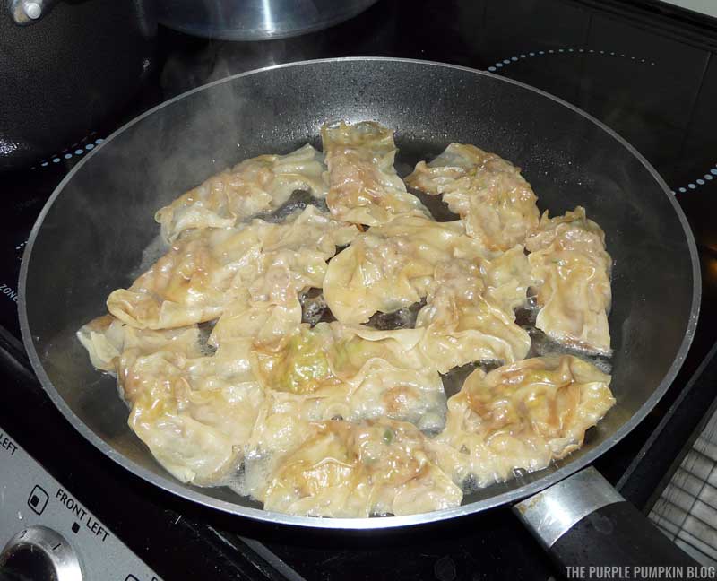 Chinese Pork Dumplings cooking in a frying pan