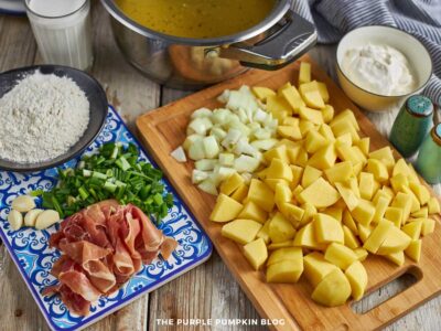Ingredients chopped for baked potato soup - potatoes, onion, garlic, bacon, and additional seasonings.