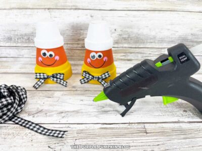Adding Bows to Clay Pot Candy Corn Pals