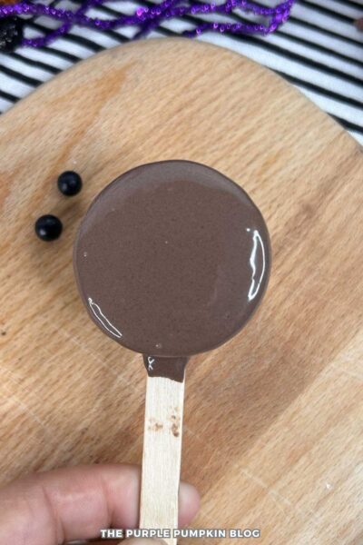 A chocolate-covered Oreo on a popsicle stick.